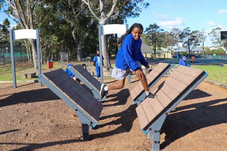 girl on outdoor ninja warrior course